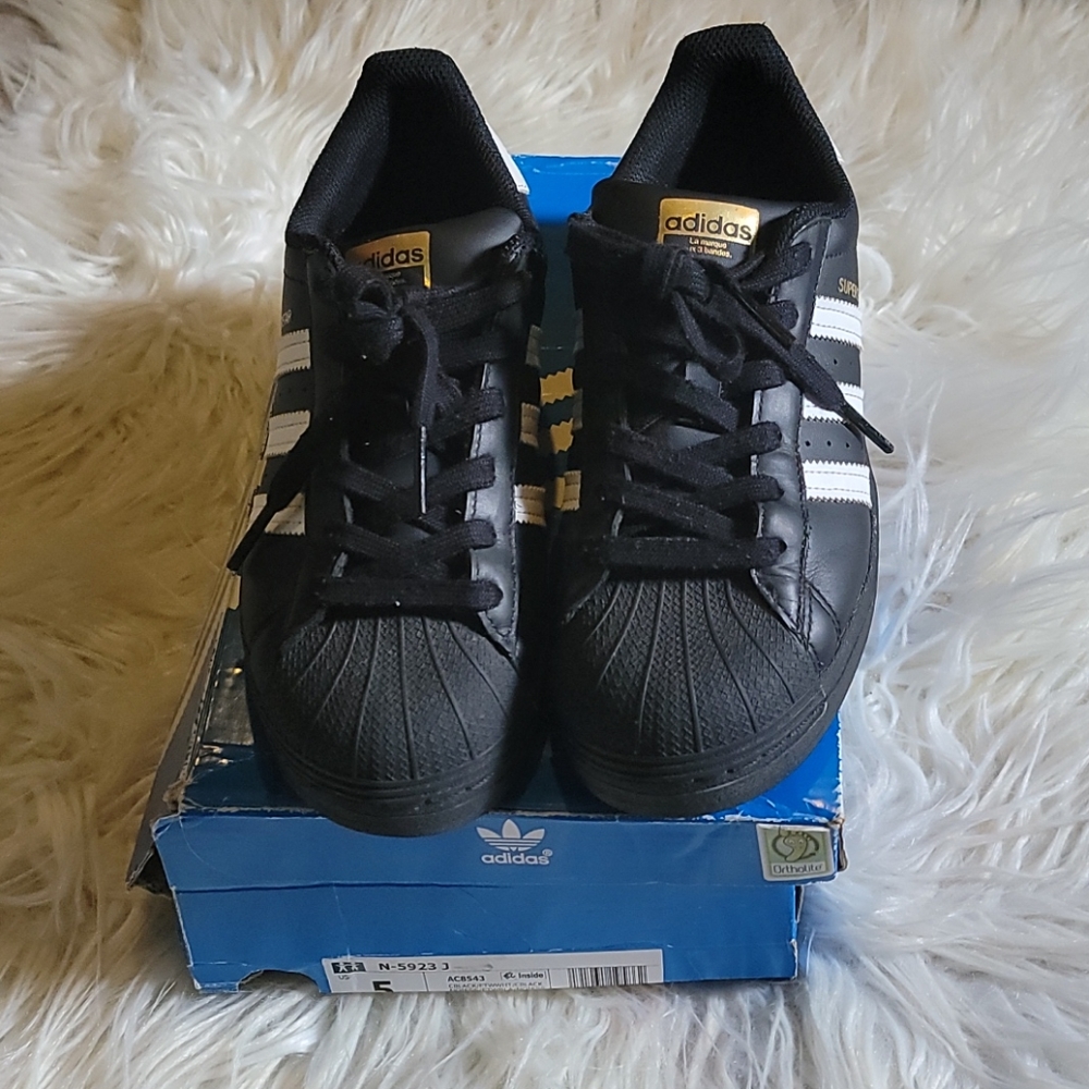 Black and white shell toe adidas